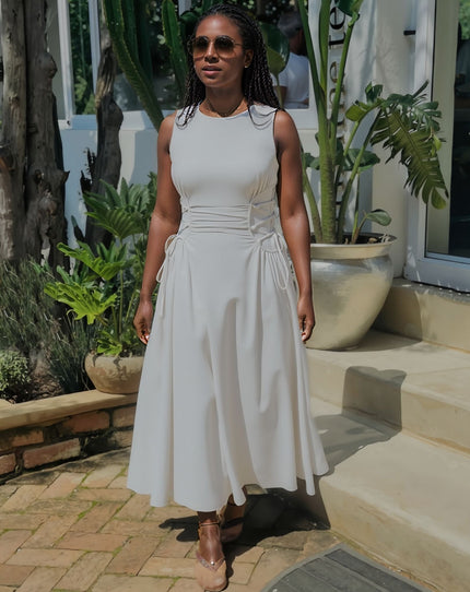 White sleeveless midi dress with waist ruching and adjustable tie detail