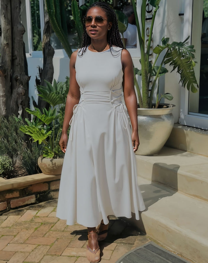 White sleeveless midi dress with waist ruching and adjustable tie detail