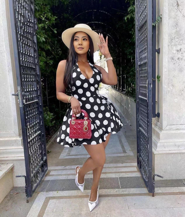 Black polka dot mini dress with flared skirt and V-neckline