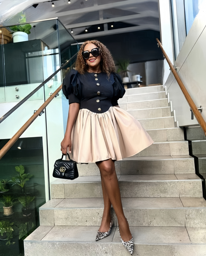 Black mini dress with puff sleeves, button front, and high-waist beige skirt