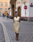 Tan sleeveless midi utility dress with V-neck and button front