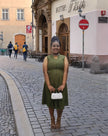 Army-green sleeveless midi utility dress with front pockets, gathered skirt and V-neck
