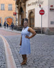 Sky-blue sleeveless midi utility dress with front pockets and buttoned waist