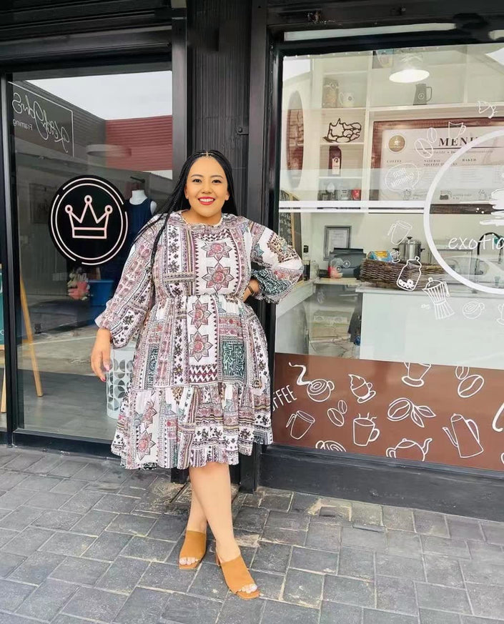 Plus size printed midi dress with flared skirt, long sleeves, multicolor geometric pattern
