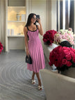 Knitted midi dress with pink base and black vertical stripes, scoop neckline, thin straps