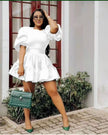 White puff sleeve mini dress with tiered ruffle hem and gathered skirt