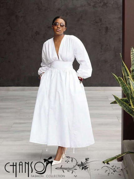 White maxi dress with deep V neck, puff sleeves, and gathered stretch waist