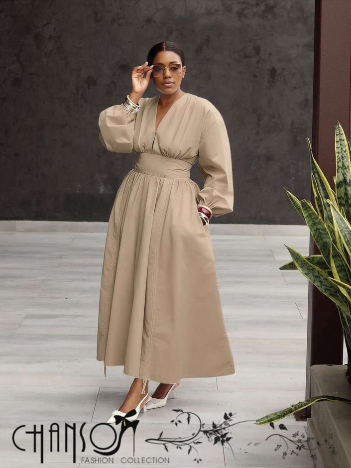 Beige maxi dress with deep V neck, long puff sleeves, and gathered stretch waist