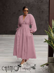 Pink maxi dress with deep V neck, long puff sleeves, and gathered stretch waist