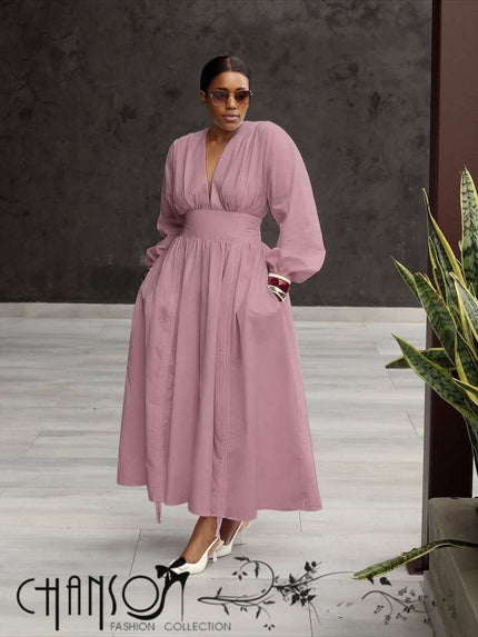 Pink maxi dress with deep V neck, long puff sleeves, and gathered stretch waist
