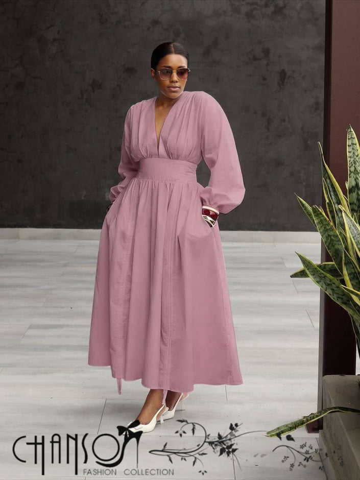 Pink maxi dress with deep V neck, long puff sleeves, and gathered stretch waist