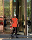 Orange-red collared shirt dress with cinched waist and button front, mini length