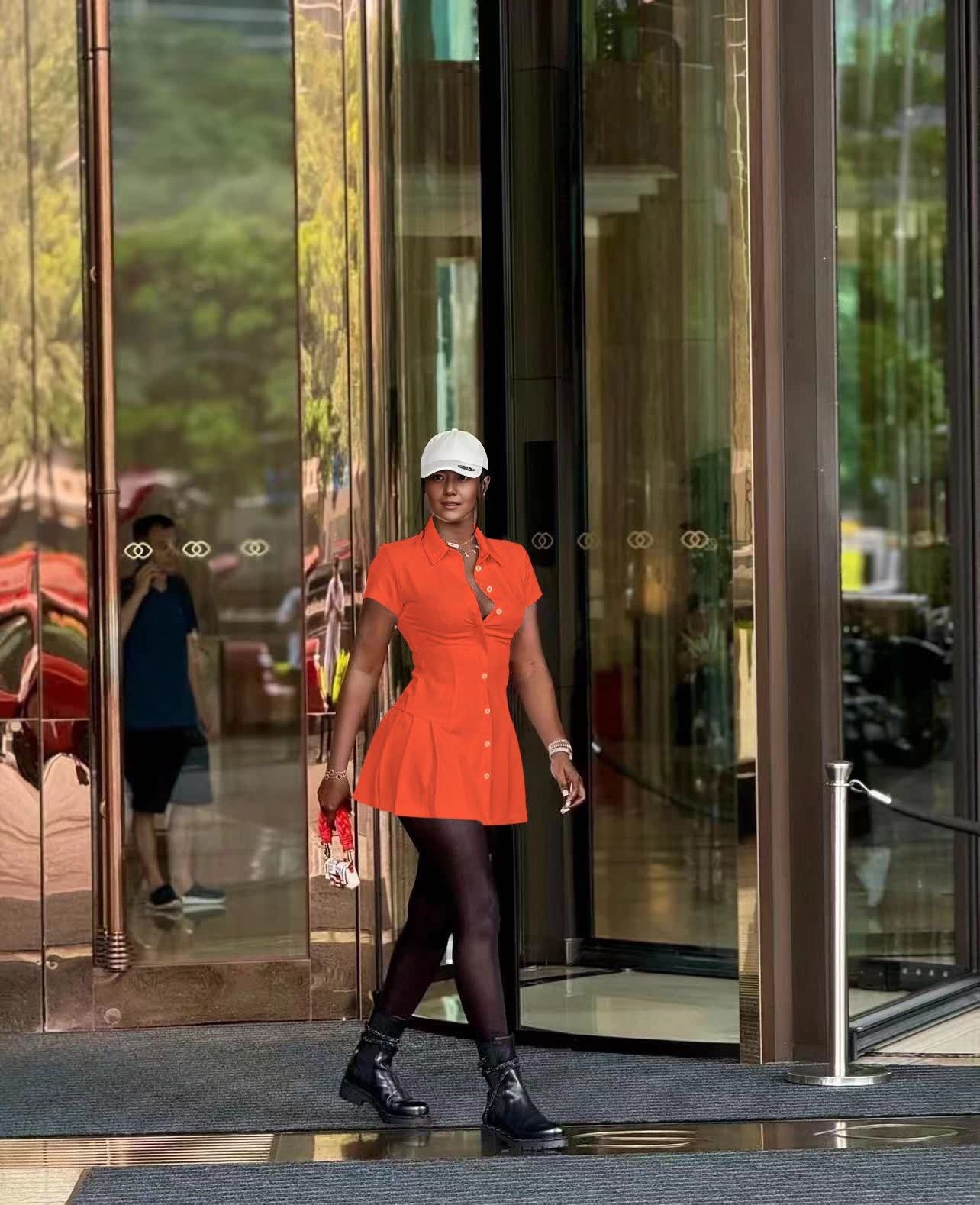 Orange-red collared shirt dress with cinched waist and button front, mini length