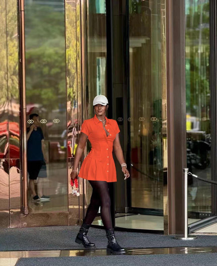 Orange-red collared shirt dress with cinched waist and button front, mini length
