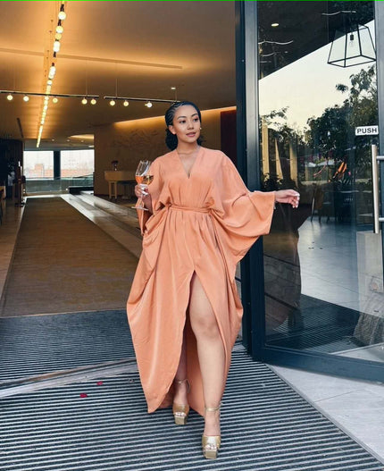 Peach loose-fit maxi dress with V-neck, long sleeves, waist tie, and front split hem