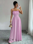 Pink pleated maxi dress with spaghetti straps, smocked bodice and long flowing skirt