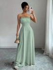Mint-green pleated maxi dress with spaghetti straps, smocked bodice and long flowing skirt