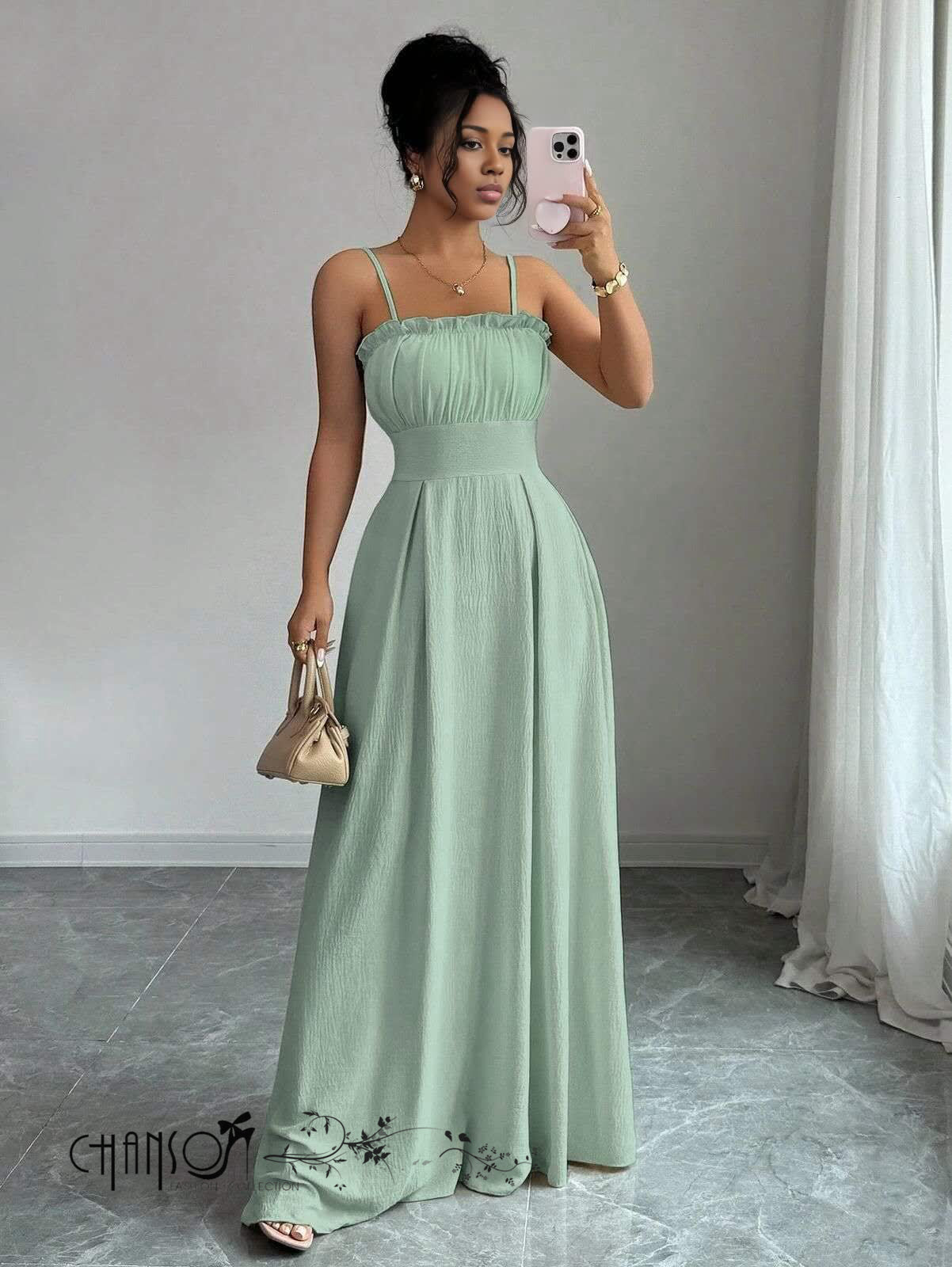 Mint-green pleated maxi dress with spaghetti straps, smocked bodice and long flowing skirt