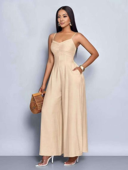 Beige pleated wide-leg jumpsuit with spaghetti straps and adjustable waist fit