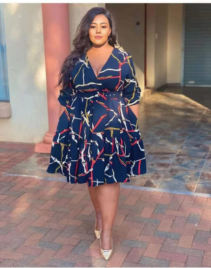 Plus size navy abstract print midi dress with V-neck and ruffle hem, long sleeves