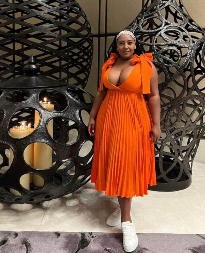 Orange-red pleated midi dress with bow shoulder straps and V-neckline