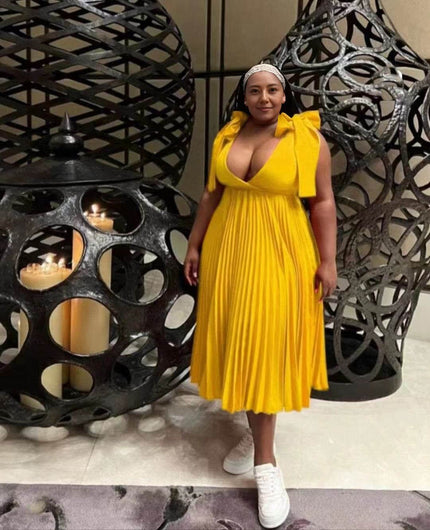 Yellow pleated midi dress with bow shoulder straps and V-neckline