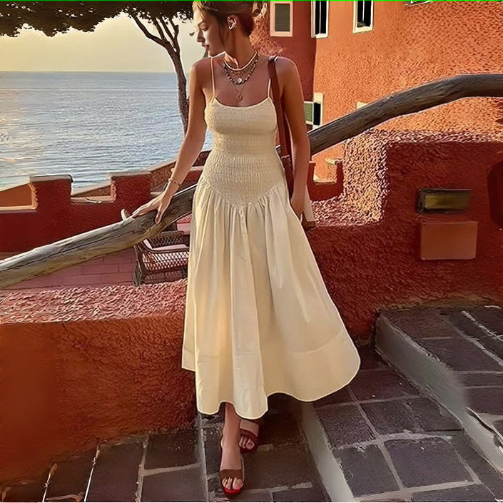 Cream smocked bodice sleeveless dress with flared skirt and tiered pleats