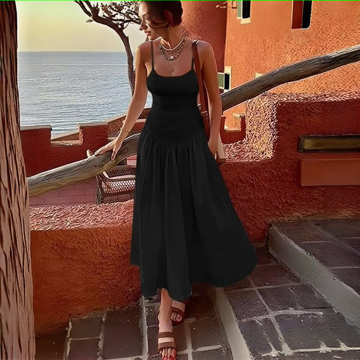 Black smocked bodice sleeveless dress with flared skirt and tiered pleats