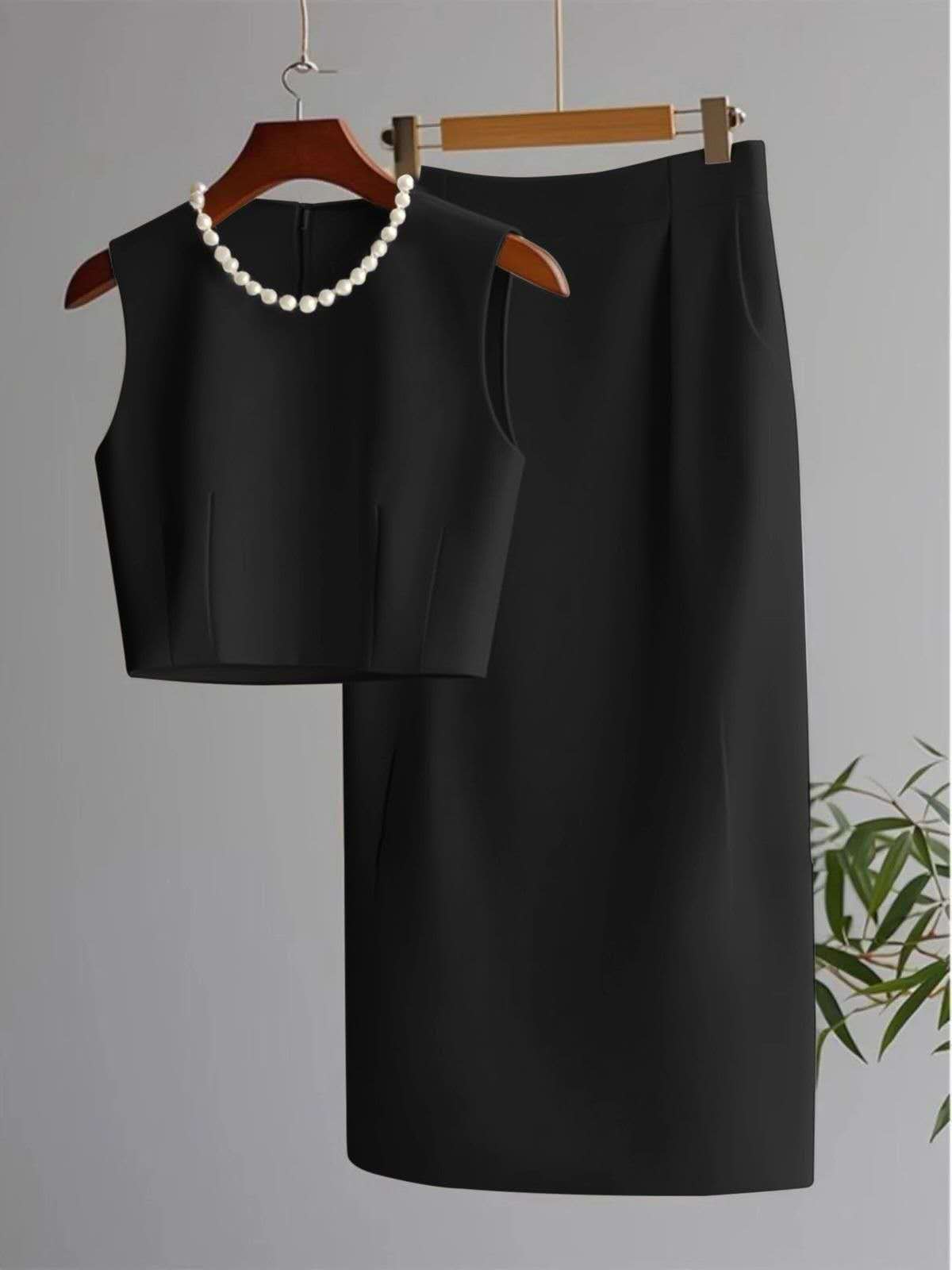 Black sleeveless cropped top and midi skirt set with pearl bead neckline