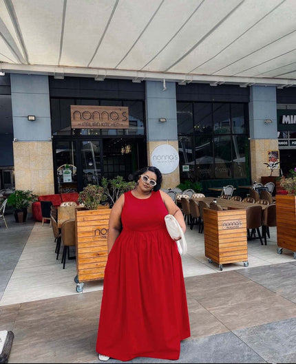 Red sleeveless maxi dress with gathered stretch waist and wide flowing skirt