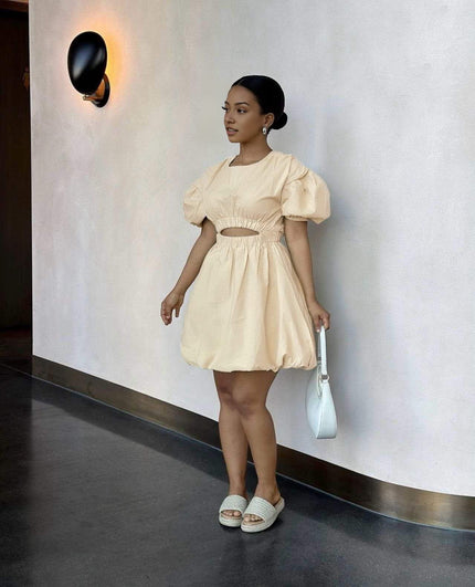 Tan mini dress with puff sleeves and cut-out waist, gathered skirt