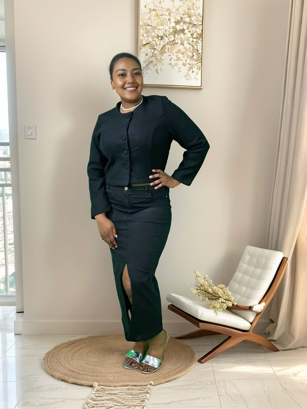 Black short button-front jacket with round neck and long sleeves