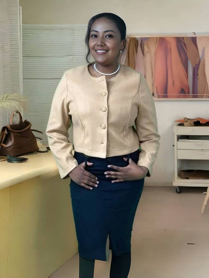 Nude short button-front jacket with round neck and long sleeves