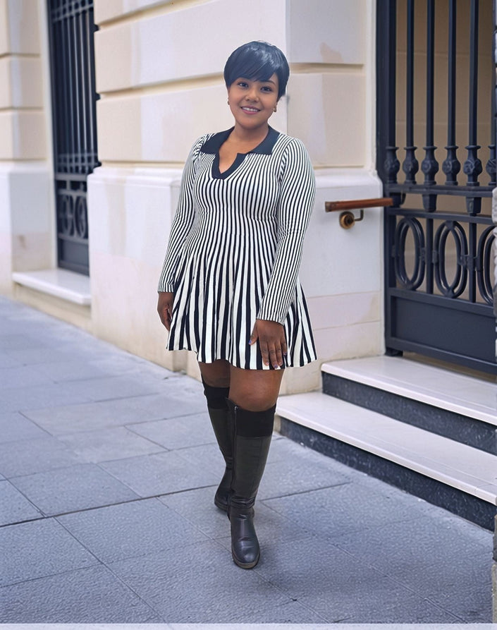 Pleated knit mini dress with vertical black-and-white stripes and V neckline