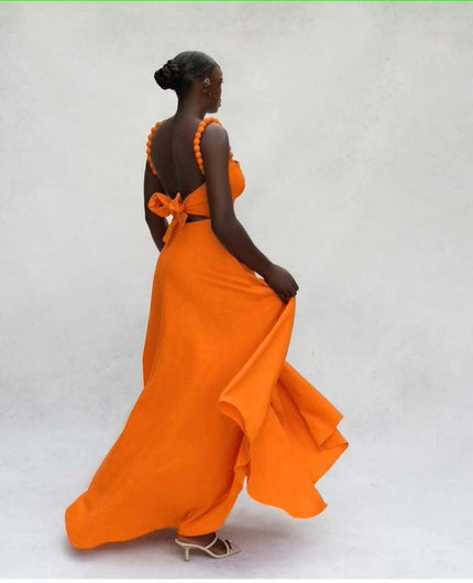Orange maxi dress, open back with pom-pom straps and bow detail