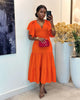 Tiered midi dress in orange-red with flutter sleeves and fitted waist