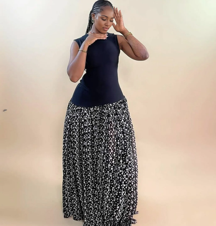 Sleeveless maxi dress with navy bodice and black skirt with scattered white dots
