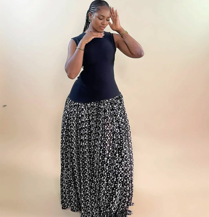 Sleeveless maxi dress with navy bodice and black skirt with scattered white dots