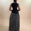 Sleeveless maxi dress back view with dark bodice and black printed contrast skirt