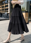 Black tiered pleated midi skirt with stretch waist and tiered ruffles