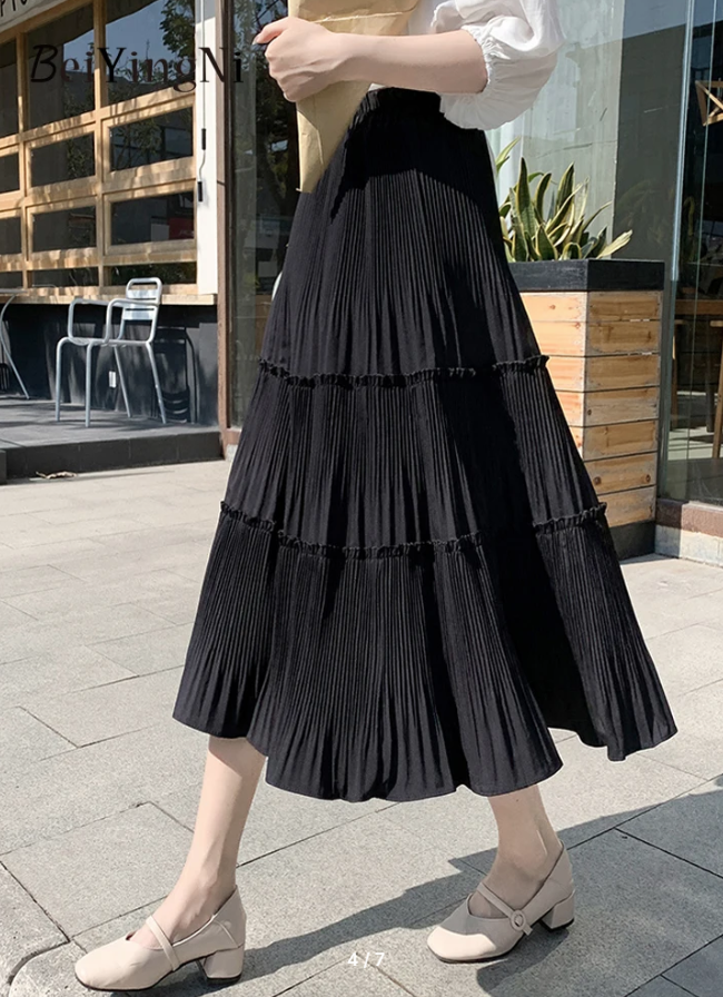 Black tiered pleated midi skirt with stretch waist and tiered ruffles