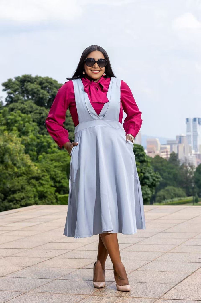 Light blue suspender midi dress with V-neck bodice and knee-length flared skirt