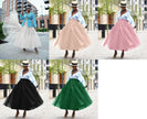 Layered tulle skirt set with voluminous black, green, pink, and white tiers