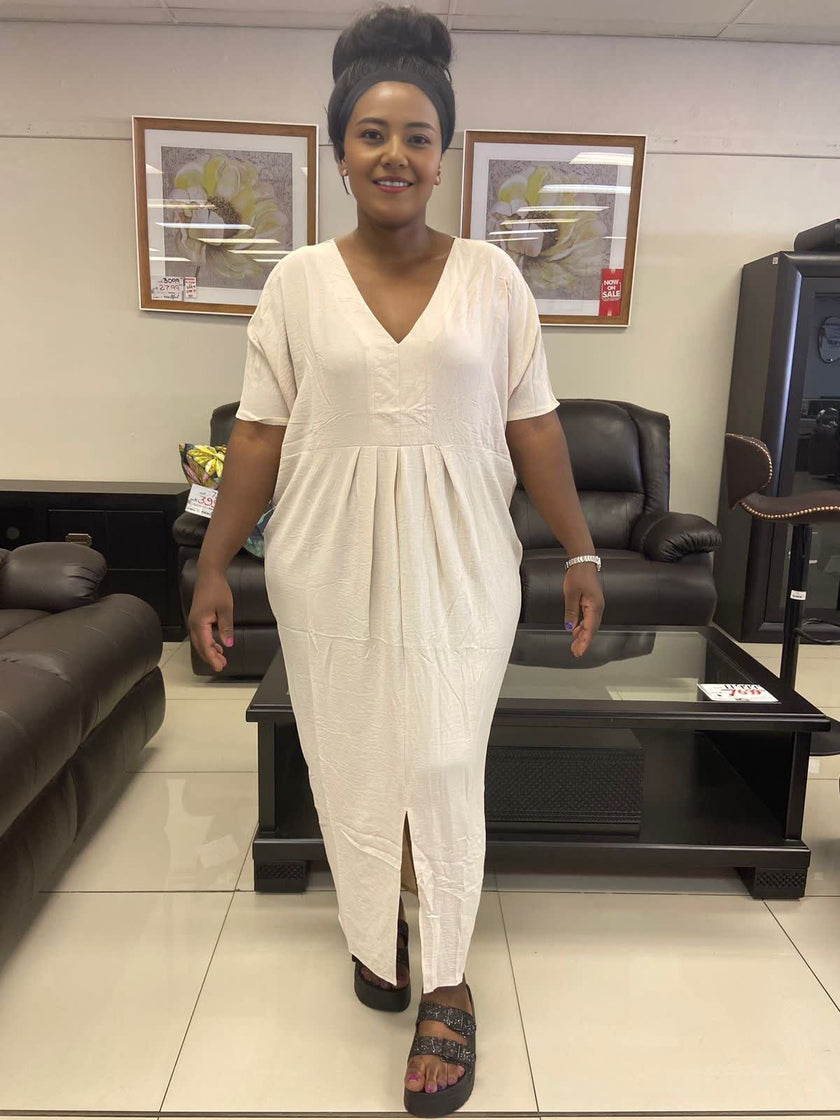Cream V-neck maxi dress with short sleeves and gathered waist, center slit