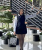 Layered shirt dress mini: black sleeveless overlay over white shirt sleeves