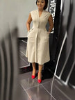 Beige sleeveless midi dress with V-neck seam and waist button accents