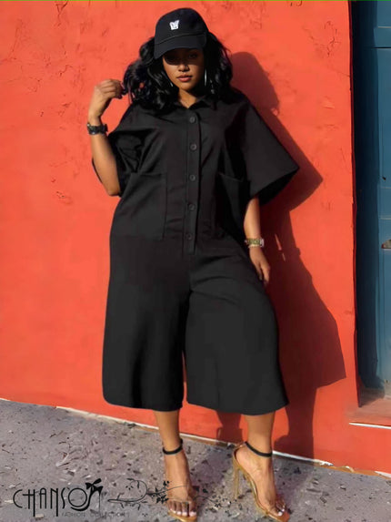 Black two-piece jumpsuit set with button-front top and wide-leg culotte bottoms, utility pockets