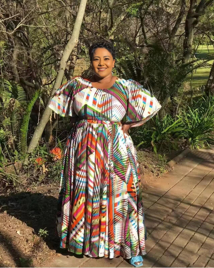 Plus size maxi dress with puff sleeves, colorful striped print, gathered waist and full skirt