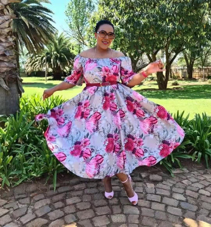 Plus size off-shoulder floral dress with pink and red blossoms on a light base