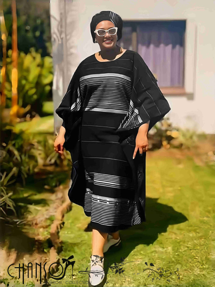 Black striped maxi dress with wide sleeves and belted waist.